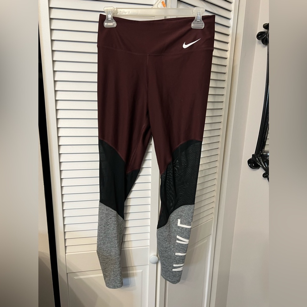 Maroon Nike leggings with logo down the leg